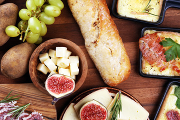 Delicious traditional Swiss melted raclette cheese on diced boiled or baked potato.