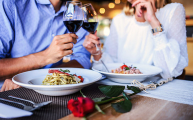 Paste and red wine, close up photo. Couple enjoying lunch in the restaurant. Lifestyle, love, relationships, food concept