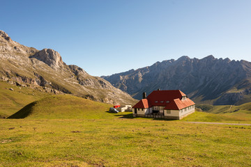 Typical farmhouse with red roofs and white walls in the mountains of the Picos de Europa