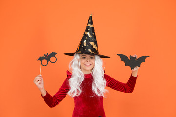 Boo to you. Little wicked witch orange background. Small child wear witch costume for holiday celebration. Halloween celebration. Photobooth for holiday celebration. All saints day celebration