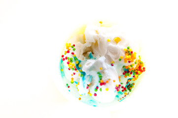 Soft tender ice cream with colored topping and syrup