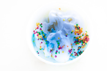 Soft tender ice cream with colored topping and syrup