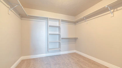 Panorama frame Empty white walk in closet with bare shelving