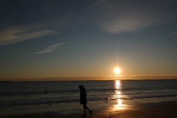 Silhouette of Man Walking on the Beach Sunrise