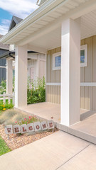 Vertical frame Front porch of modern home with welcome sign