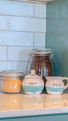 Vertical frame Glass storage jars with coffee and sugar