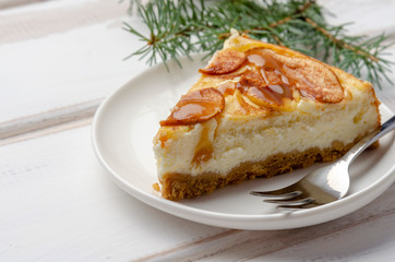 Christmas holiday cheesecake with apples. On wooden table with copy space