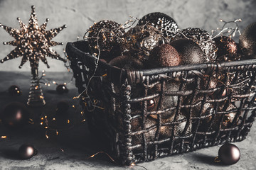 Wicker basket with Christmas toys and holiday decorations lights, copy space, new year decoration