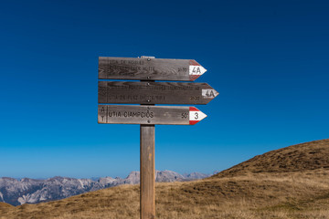 wooden sign in the mountains, dolomite alps, south tyrol