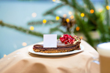 Delicious morning sweet chocolate cupcake dessert on the wooden table, fireflies and spruce branches