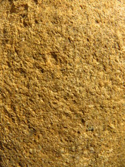 Close up texture of a sandstone river stone worn round.