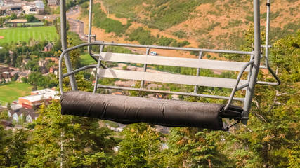 Panorama Close up of an empty chairlift overlooking Park City landscape during off season