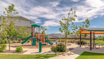 Panorama Park at a sunny neighborhood with childrens playground and pavilion eating area