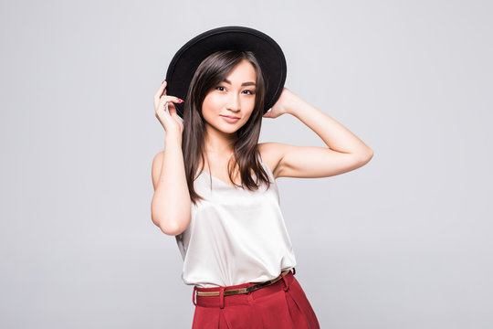 Portrait of Smiling asian woman with black hat isolated on white background