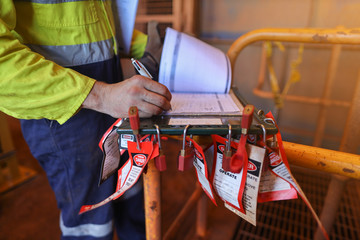 Personnel red locks attached with danger tag together with safety isolation permit lock box...