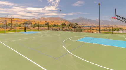 Panorama frame Outdoor turf basketball court on sunny, clear day