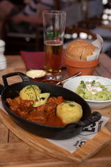A Hungarian Chicken Paprikash with potato dumplings