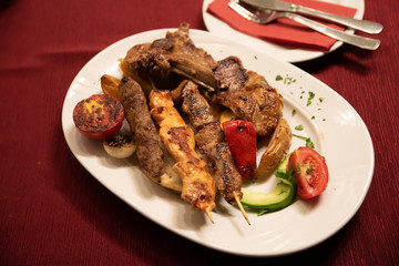 A mixed grill plate of chicken kabobs, steak, lamb, and chops