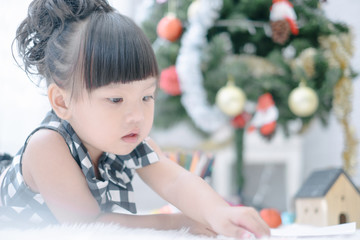 Fototapeta na wymiar Merry christmas happy little child with beautifully decorated christmas tree holidays in home, christmas concept