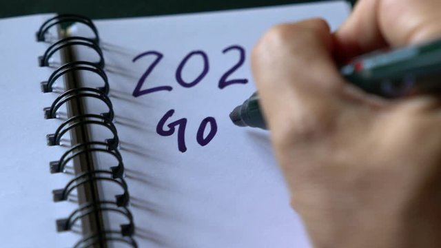 New year, new goals. Writing down 2020 goals on a notepad. Start planning for new year goals and resolution.