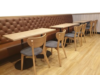 Brown leather sofa and wooden chair with square table isolated on white background with copy space. empty restaurant