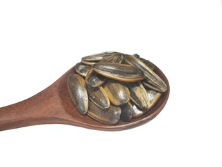  Roasted Sunflower seeds on a wooden spoon isolated on white background with copy space.  super food goo
