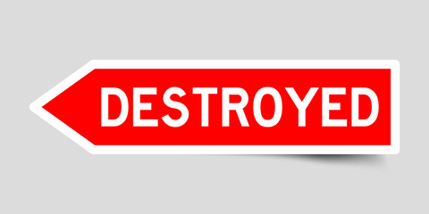Red color arrow sticker with word destroyed on gray background