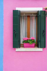 Windows of Venice, Murano and Burano. Picturesque windows with shutters on the famous island Burano. Decorated window on colorful wall in Burano island, Venice, Italy