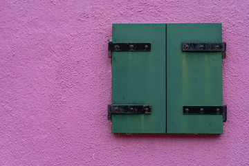 Windows of Venice, Murano and Burano. Picturesque windows with shutters on the famous island Burano. Decorated window on colorful wall in Burano island, Venice, Italy