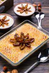 Vanilla date pudding on a glass serving dish on a wooden table