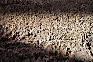 Old vintage wall in strong sidelight beam of light, light and shadow concept.