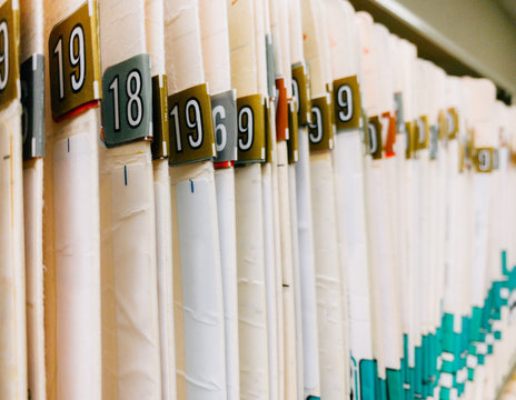 medical record charts on shelve sorted alphabetically