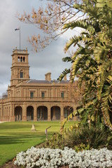 Fototapeta premium details of the old world architecture on the grand mansion viewed through the gardens at Werribee mansion, an old large Australian property near Melbourne Victoria, Australia