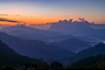 Sunset or sunrise mountain peaks colorful sky panorama.