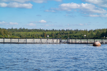 Fototapeta premium Large fish tanks on the river, salmon fish farm