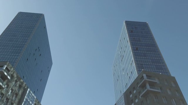 skyscraper, tall building, blue sky and smooth camera movements. 4k and 50 fps