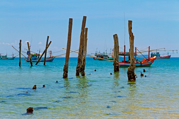 Beach with blue sky and fishing boat