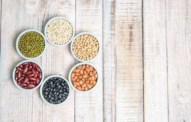 A variety of nuts in a cup on a Wood backgroun