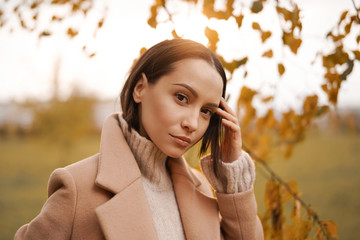 Beautiful lady in autumn landscape