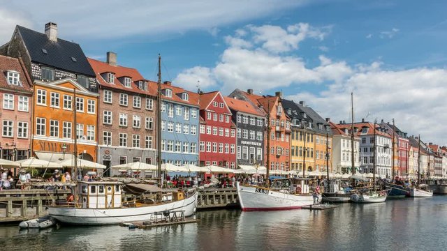 Colorful houses facades and sailing boats at Nyhavn canal, one of the most vibrant places in Copenhagen, Denmark