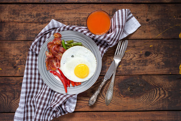 breakfast - fried eggs, siliculose haricot, bacon, a paprika and juice on a table, selective focus, top view, copy space