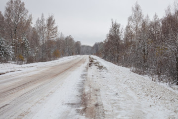 Fototapeta na wymiar the snow-covered winter road in the wood