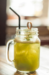 A close-up view of cucumber and lemon juice on a wooden table