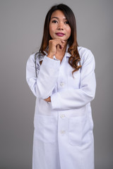 Portrait of Asian woman doctor with wavy hair