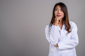 Portrait of Asian woman doctor with wavy hair