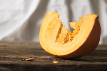 Fresh pumpkin on the table from old boards. Horizontal orientation and white background.