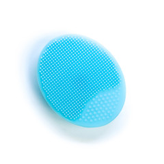 Blue rubber face wash brush. Close up. Isolated on white background