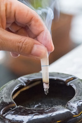 Hand hold cigarettes going to quit smoking