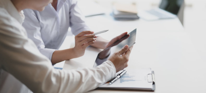 Cropped shot of two professional business partner discussing their project together