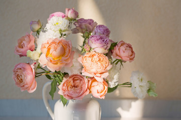 beautiful roses in ceramic white jug